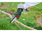 Pruning branches with a compact cordless chainsaw