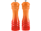 Two orange-red gradient salt and pepper mills.