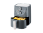 Grey air fryer with a basket full of golden french fries, showing temperature and timer dials.