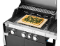 Gas grill with vegetable pizza on a pizza stone