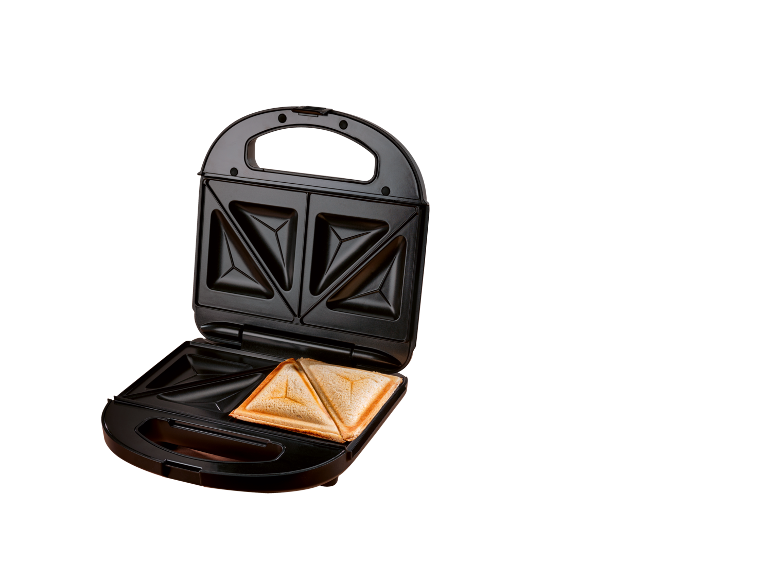 Open sandwich maker with one toasted sandwich inside on a black background.