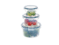 Stacked round food containers with limes, tomatoes, and lettuce.