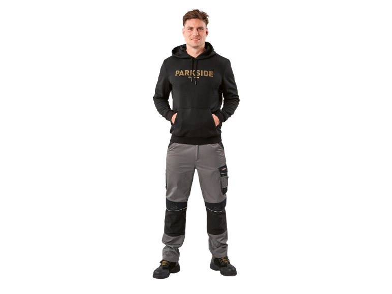 Man in black hoodie and grey work trousers.