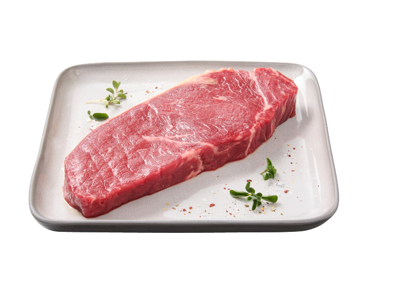Raw beef steak with herbs and spices on a rectangular plate.