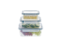 Stacked food containers with cheese cubes, cucumber slices, and grapes.