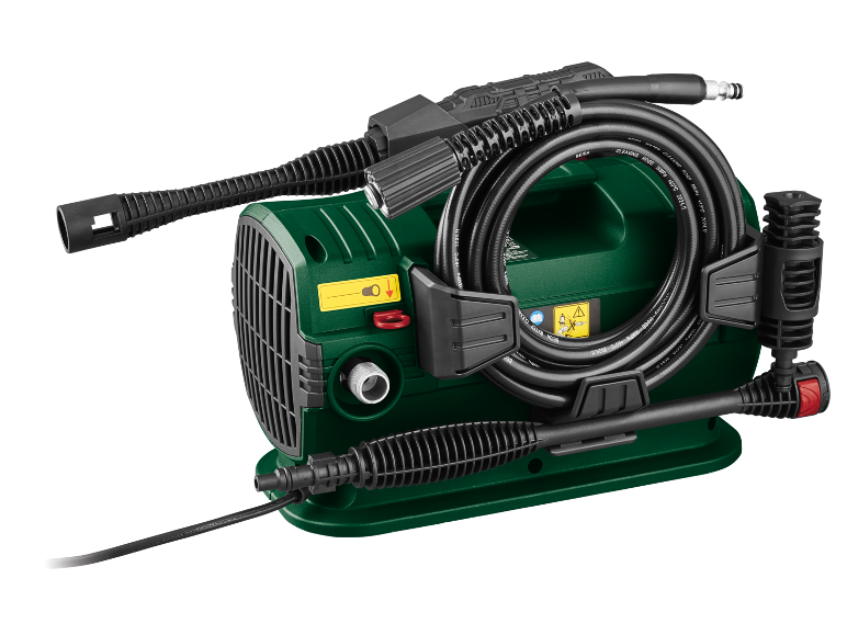 Green pressure washer with hose and accessories on a black background.