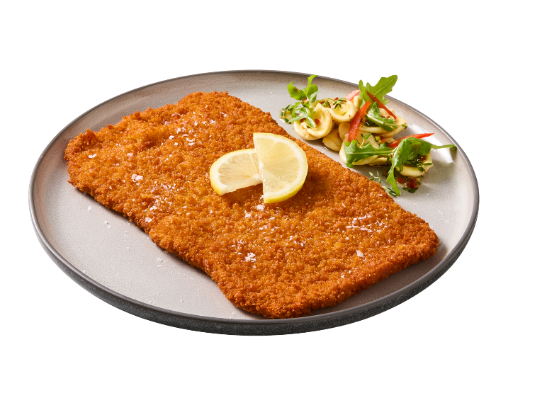 Breaded schnitzel with lemon and pasta salad on a plate.