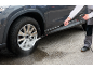 Pressure washer cleaning a dirty car wheel.