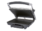 Open electric grill with black ribbed plates and a silver handle.