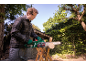 Man cutting wood with an electric chainsaw outdoors.