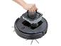 A hand removes the water tank from a black robotic vacuum cleaner.