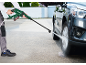 Man cleaning car with a cordless pressure washer.