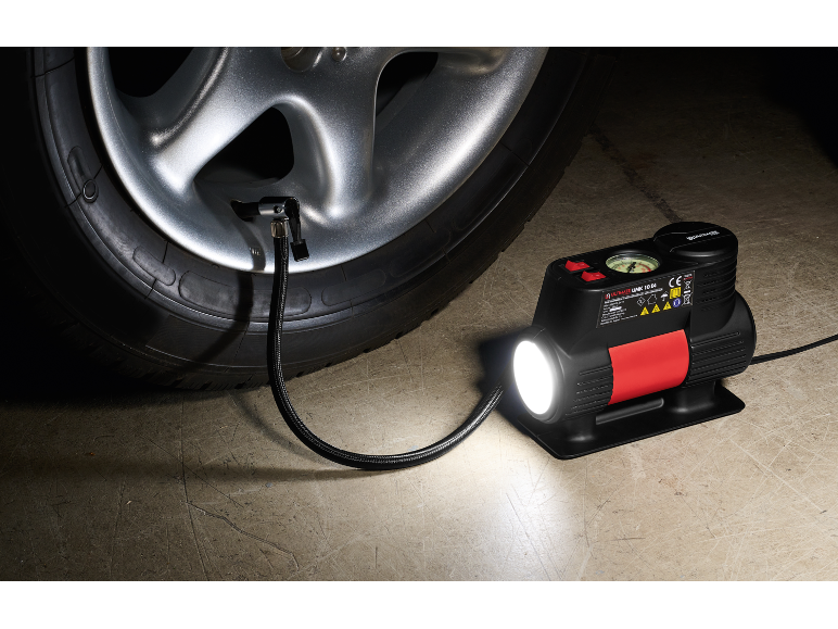 Car compressor with flashlight inflating a car tire