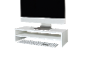 White monitor stand with a computer monitor and keyboard on a black background.