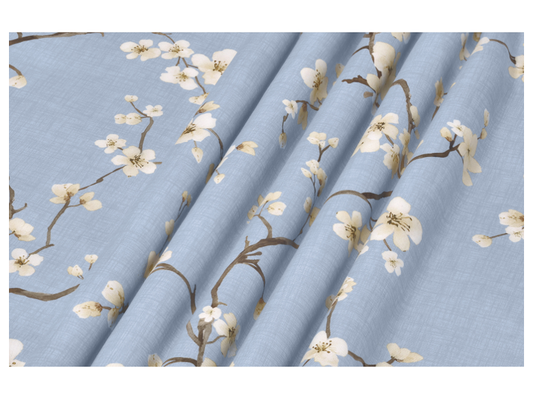 Light blue textile with a pattern of blooming cherry branches.