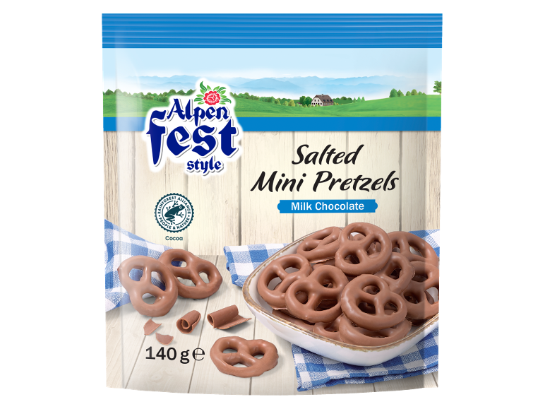Bag of salted milk chocolate mini pretzels, with an alpine landscape in the background.