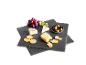 Cheese board with various cheeses, grapes, olives, and crackers on a dark background.