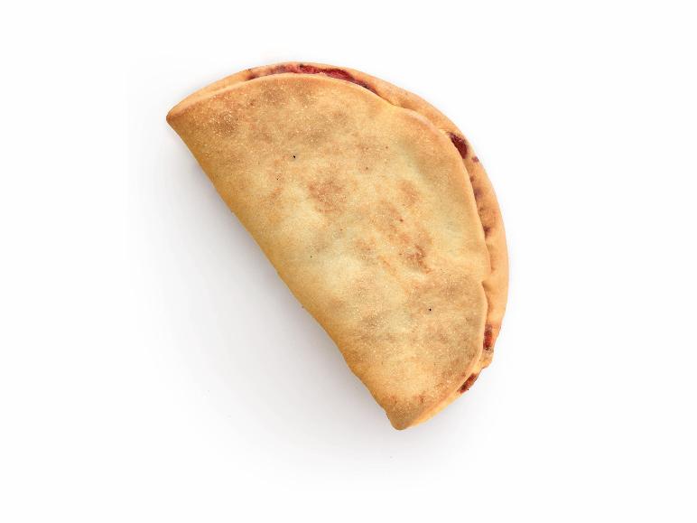 Baked calzone with a golden crust and visible red filling on a white background.