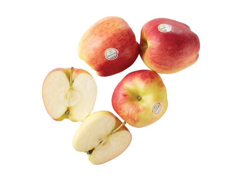 Red and yellow apples, some cut in half, with fruit stickers.