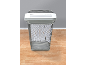 White paper shredder in a mesh waste bin on a wooden floor.