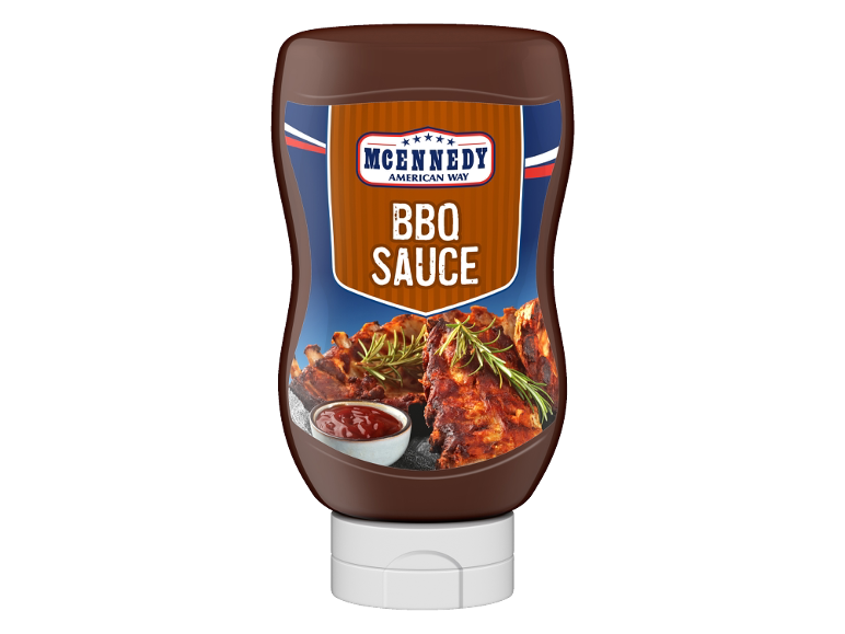 BBQ sauce bottle with grilled ribs and a bowl of sauce.