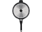 Bottom of a frying pan with a handle and an induction base with a dotted pattern.