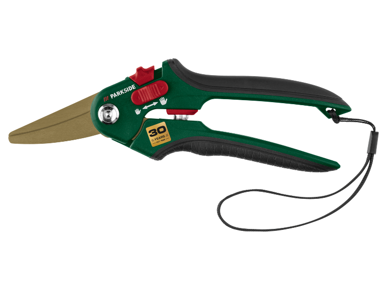 Green grass shears with golden blades and black handle, featuring '30 YEARS – EST. 1996'.