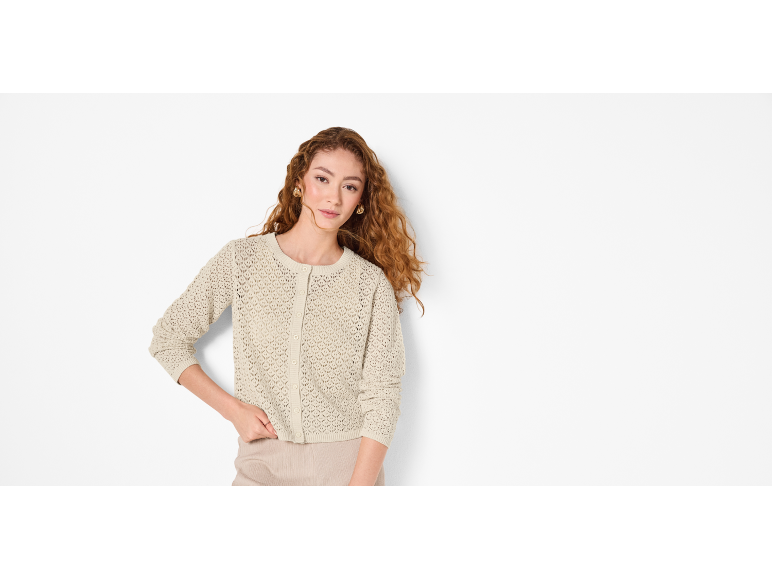 Woman with curly hair and beige knitted cardigan