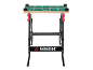 Black folding workbench with a wooden top and a green measuring surface.