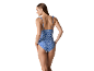 Women's blue one-piece swimsuit with thin straps and abstract print, back view.