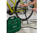 Air compressor inflating a bicycle tire, pressure gauge visible.