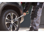 Man tightening car wheel bolts with a torque wrench.