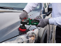 Person polishing a dark grey car with an electric car polisher.
