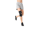 Black sports knee brace on a leg, grey shorts, and black sneakers.