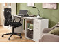 White desk with black office chair, desk lamp, and monitor in a modern workspace.