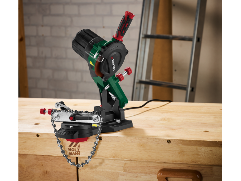 Electric chain sharpener on a wooden workbench.