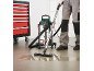 Wet and dry vacuum cleaner with stainless steel tank, cleaning a puddle of water from the floor.