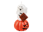 Halloween candle featuring a ghost holding a 'Trick or Treat' sign, sitting on a jack-o'-lantern.