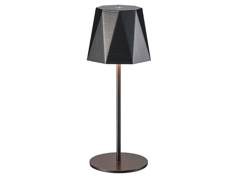 Black table lamp with a geometric shade and a round base.