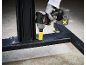 Cordless impact wrench with battery pack tightening a bolt on a metal frame.