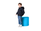 Smiling boy in dark blue puffer jacket, jeans, and white sneakers.