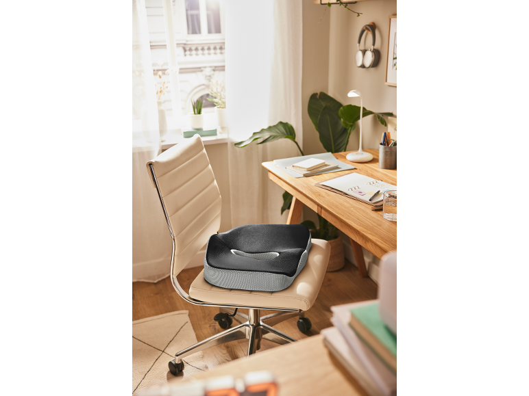 Ergonomic seat cushion on an office chair in a home office setting.