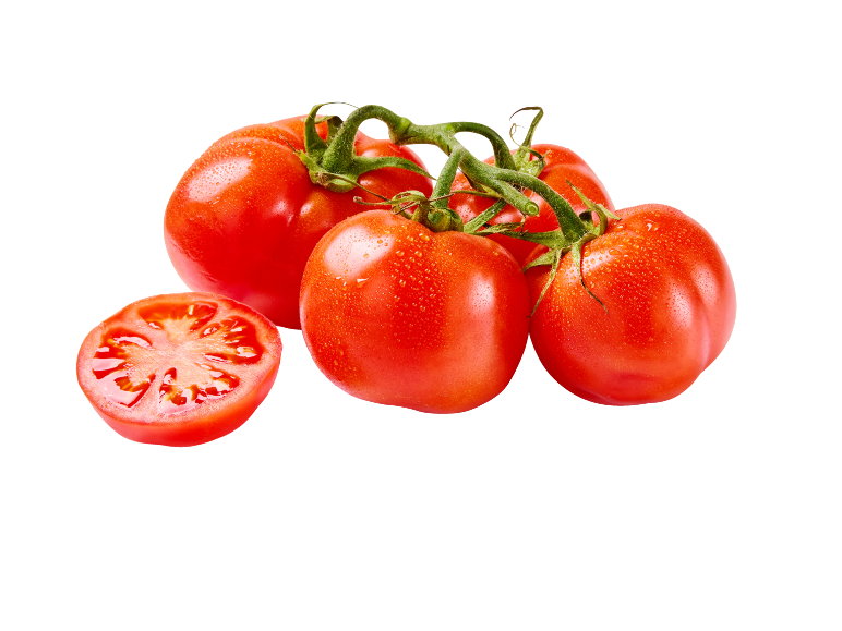 Fresh red tomatoes on the vine, one sliced in half, with water droplets.
