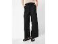 Black wide-leg trousers with drawstring and braided sandals.