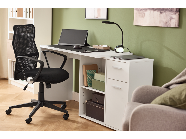 White desk with black office chair, desk lamp, and monitor in a modern workspace.