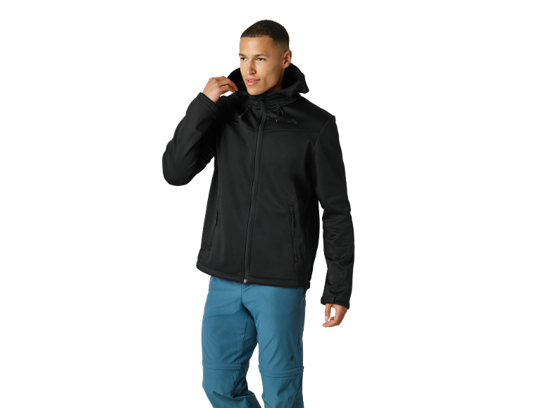 Man in a black hooded softshell jacket and blue outdoor trousers