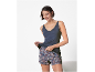 Woman in blue camisole and floral patterned shorts.