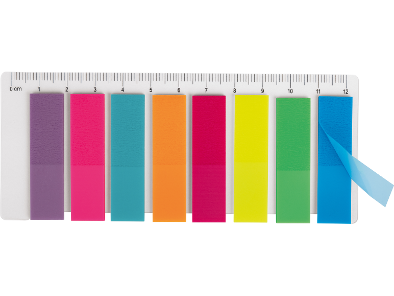 Colorful sticky page markers on a ruler, with one blue marker peeling off.