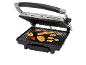 Electric grill with an open lid, grilling chicken, vegetables, and mushrooms.