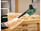 Cordless blower cleaning wood shavings from a workbench.
